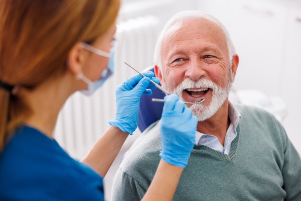 Patient smiling during an All-on-4 dental implant consultation